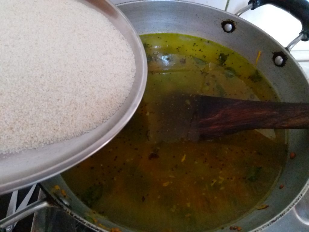 Adding Roasted Rava for Rava Upma Recipe
